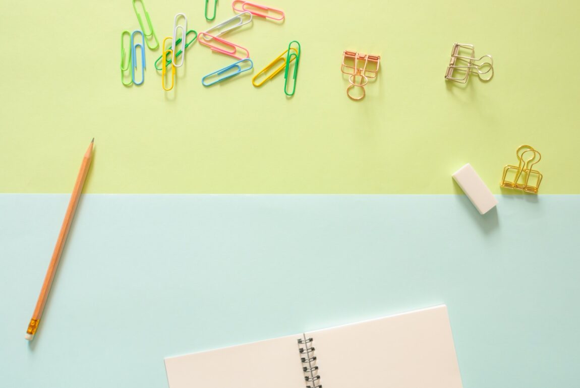 stationery items on a colourful desktop Photo by Tirachard Kumtanom: https://www.pexels.com/photo/assorted-color-metal-clips-on-table-beside-pencil-and-notebook-584305/