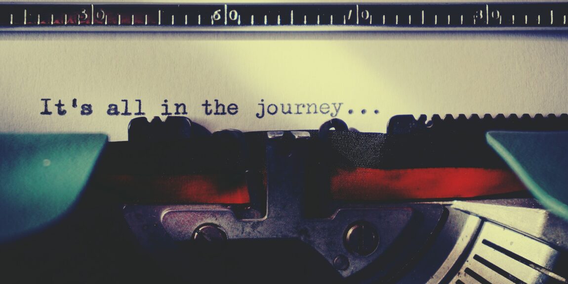 typewriter with text "it's all in the journey" written on a sheet of paper Photo by Suzy Hazelwood: https://www.pexels.com/photo/black-typewriter-machine-typing-on-white-printer-paper-1303835/
