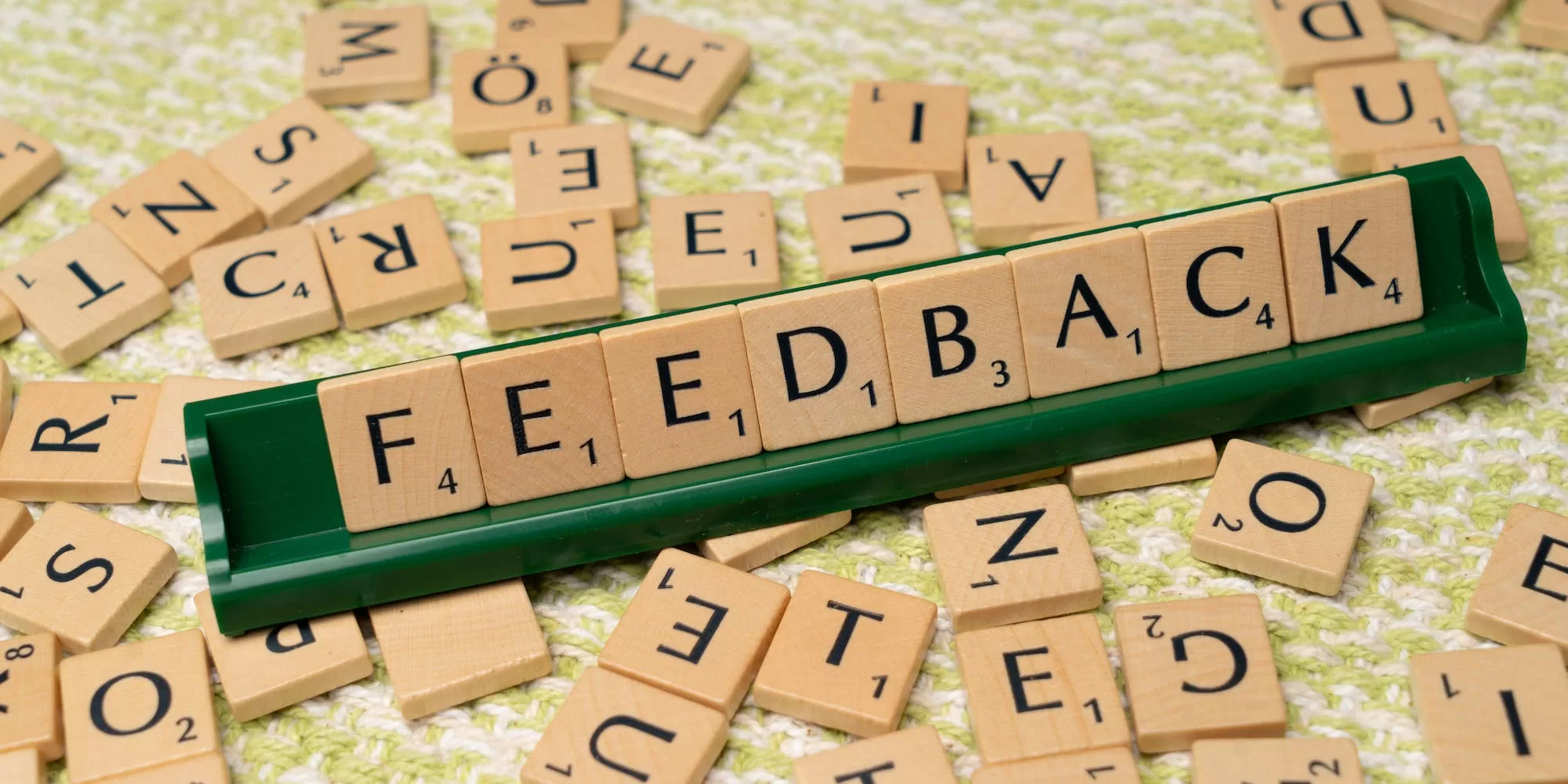scrabble letter tiles with some letters on a tray spelling feedback Photo by Markus Winkler: https://www.pexels.com/photo/the-word-feedback-is-spelled-out-with-scrabble-tiles-18512803/