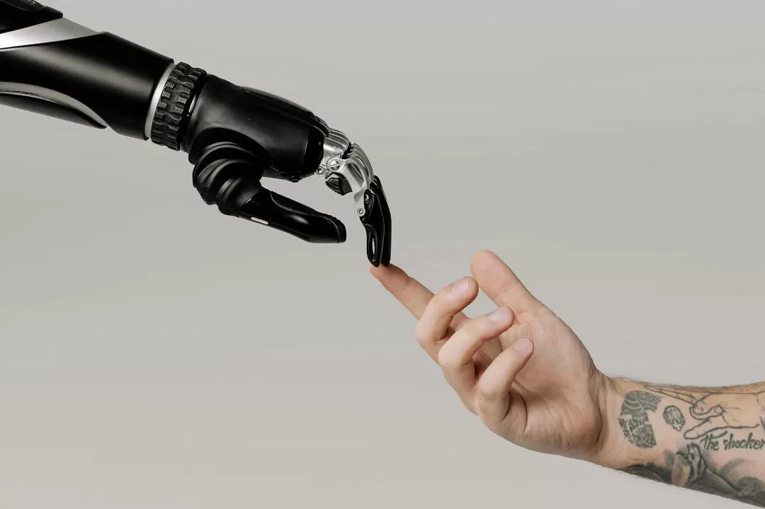 robotic and human hands touching